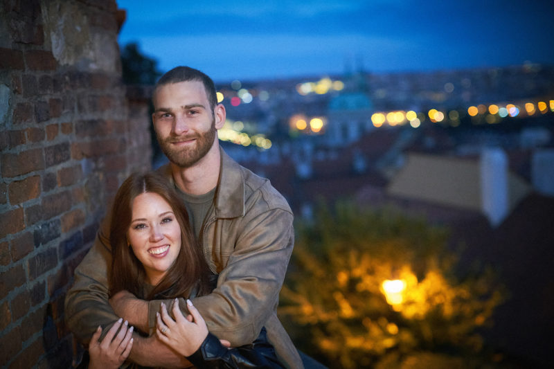 Max and Bryanna pose for a photo at Prague Castle celebrating their engagement.
