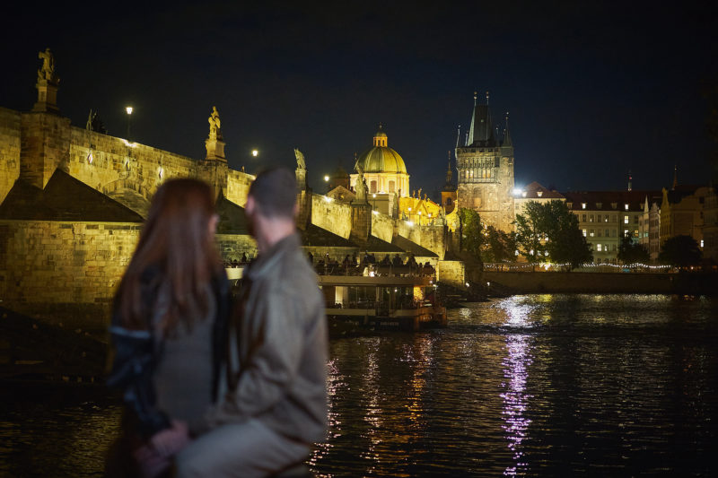 The Charles Bridge provides the romantic backdrop as Max and Bryanna watch the boats traverse underneath.
