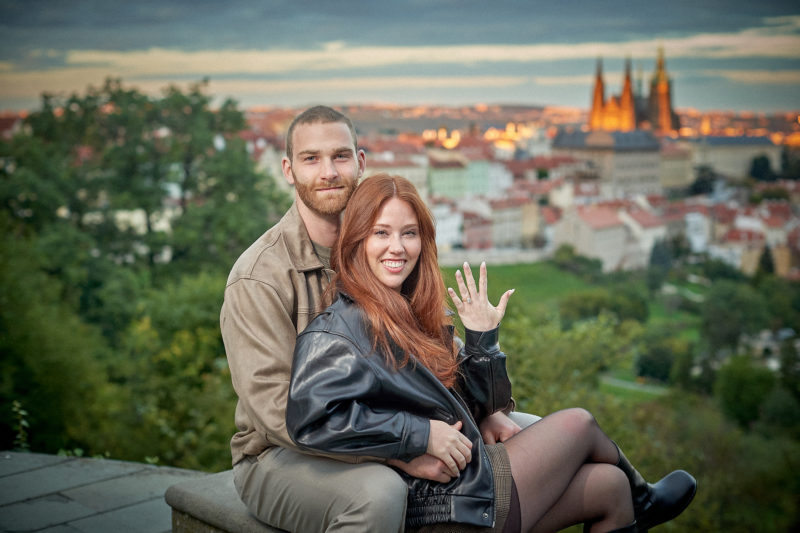The radiant newlyweds pose for a photo after the surprise proposal in Prague.