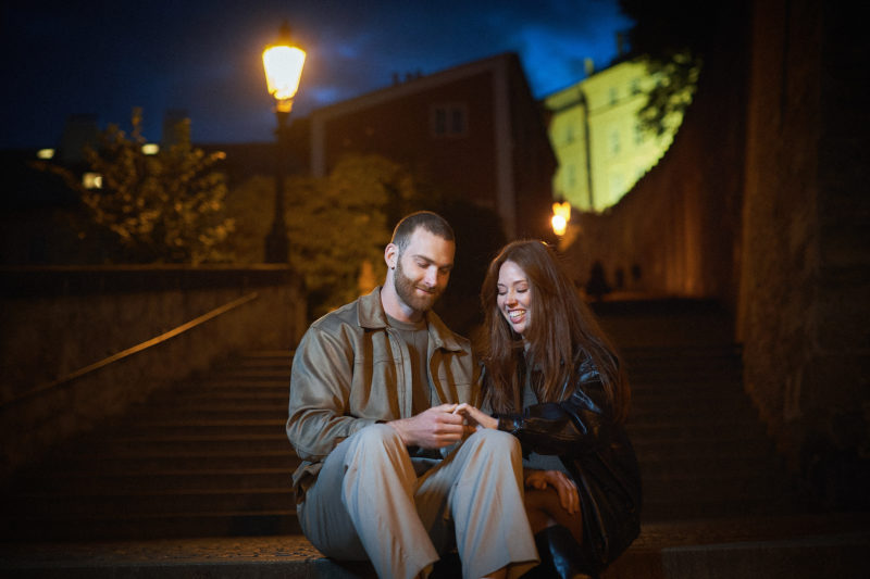 Max and Bryanna smile as they look at the diamond engagement ring following their engagement.